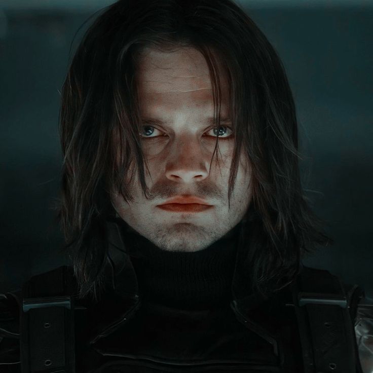 headshot of the Winter Soldier looking brooding directly at the camera. His hair falls slightly in his face.